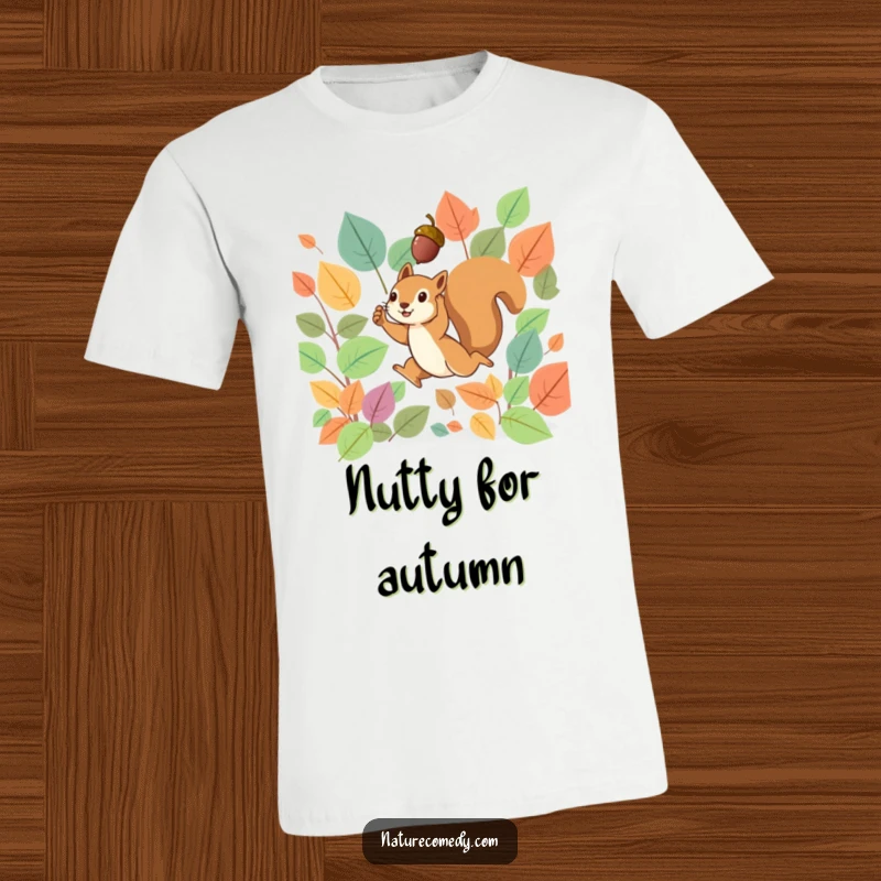 Funny t-shirt depicting a tiny squirrel leaping dynamically through a cascade of vibrant, colorful autumn leaves, holding an acorn up high.